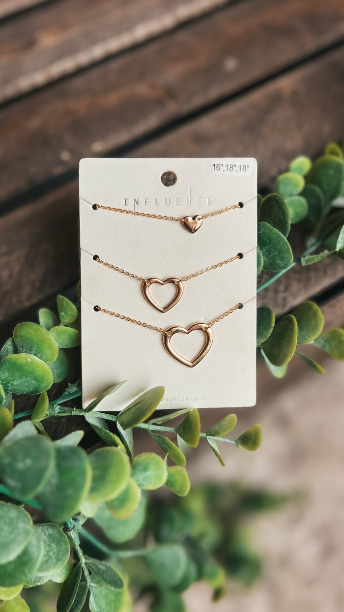 Triple heart necklace set in gold